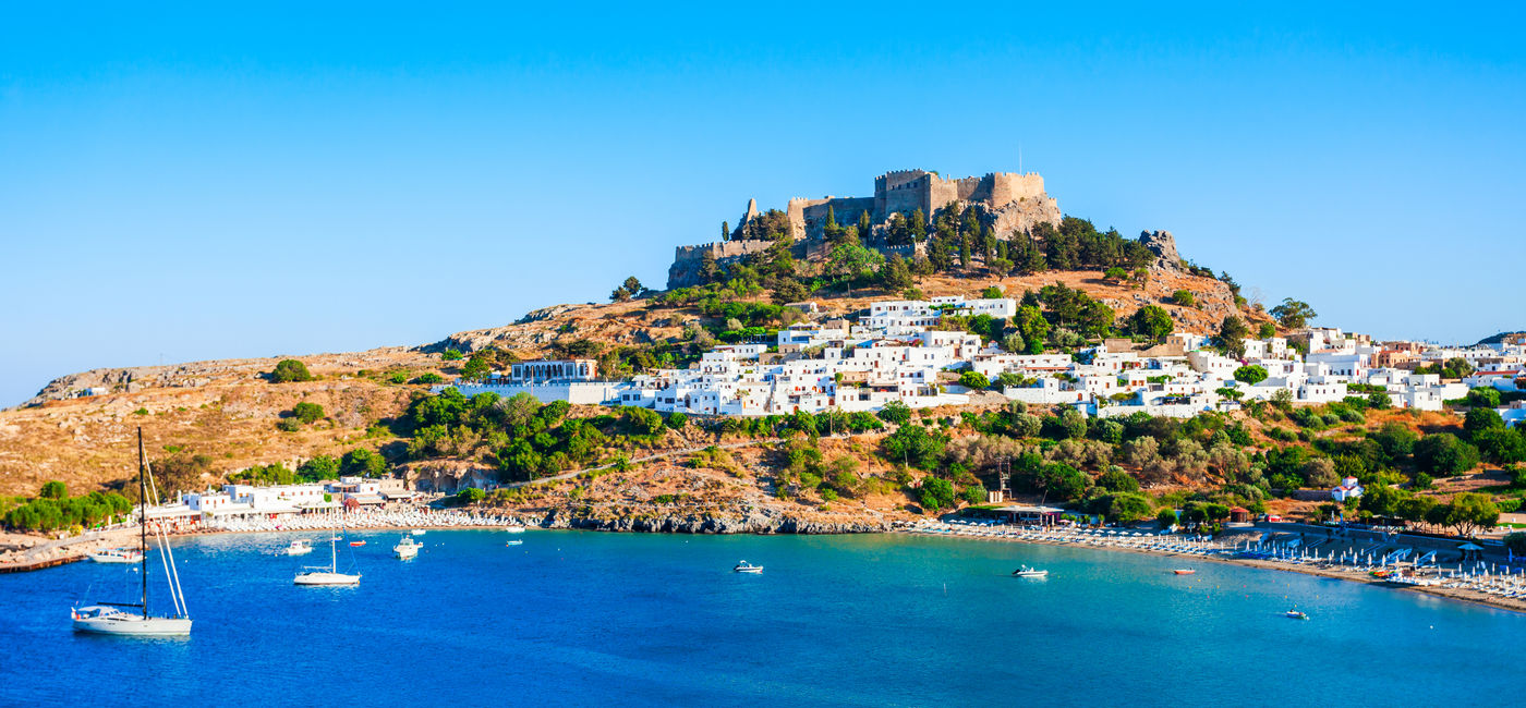 Image: Lindos Acropolis and beach, Rhodes, Greece.  (Photo Credit: saiko3p / Adobe Stock)