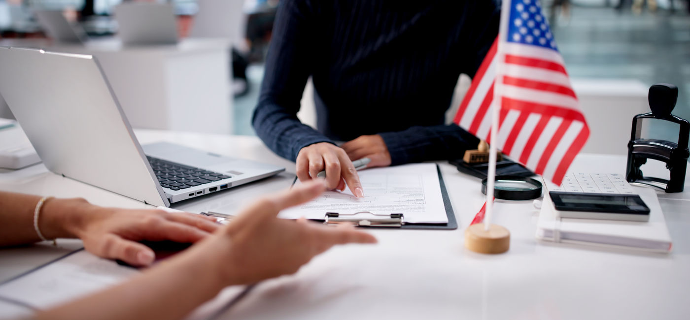 Image: Woman interviewing for a US visa application. (Photo Credit: Adobe/Andrey Popov)