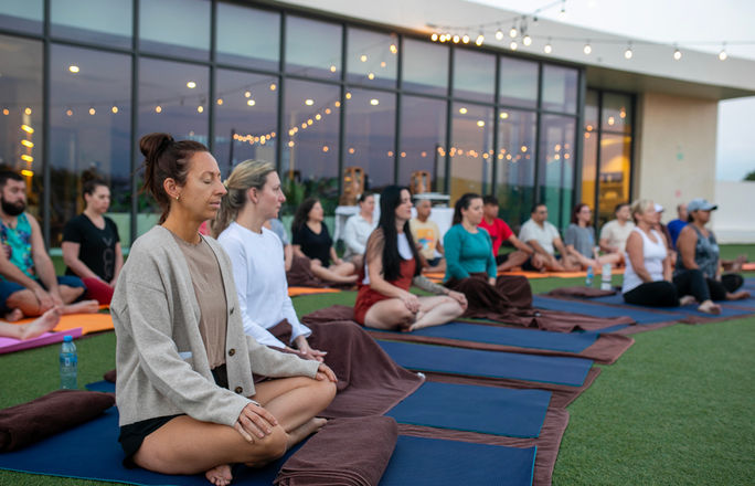 Confidant Connect LIVE 2024 attendees participating in yoga