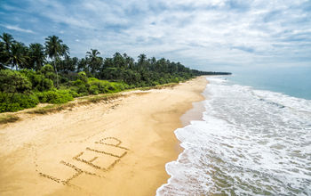 The message 'Help' written on the sands of a tropical beach.