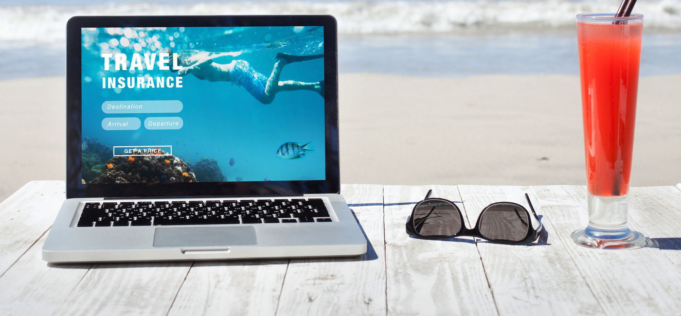 Image: Shopping for travel insurance on a tropical beach. (Photo Credit: Adobe Stock/Song_about_summer)