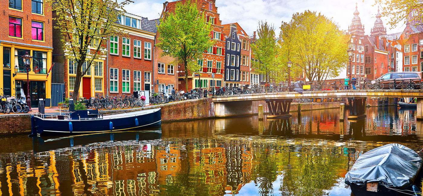 Image: Historic buildings and channel in Amsterdam's historic center.  (Photo Credit: Adobe Stock/Yasonya)