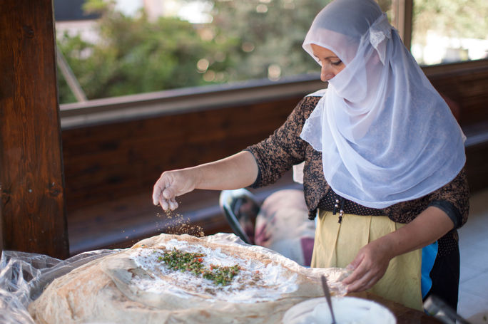 A Druze woman prepares traditional wraps. A Druze woman prepares traditional wraps.