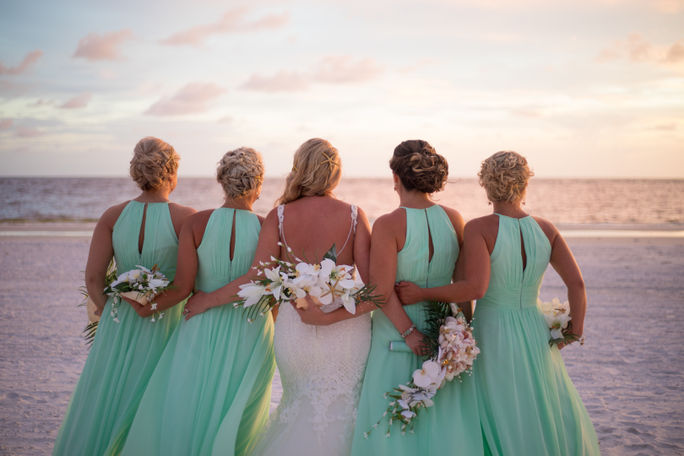 Bride and bridesmaids on the beach