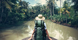 Woman sitting on the edge of a river