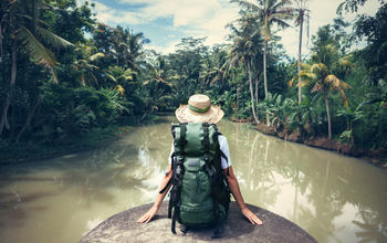 Woman sitting on the edge of a river