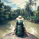 Woman sitting on the edge of a river