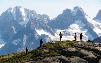 Travelers hiking with mountains in the background