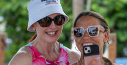 President Laura Hodges Bethge takes a photo with a guest during Celebrity Cruises' 2024 President's Cruise.