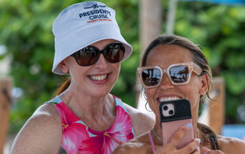 President Laura Hodges Bethge takes a photo with a guest during Celebrity Cruises' 2024 President's Cruise.