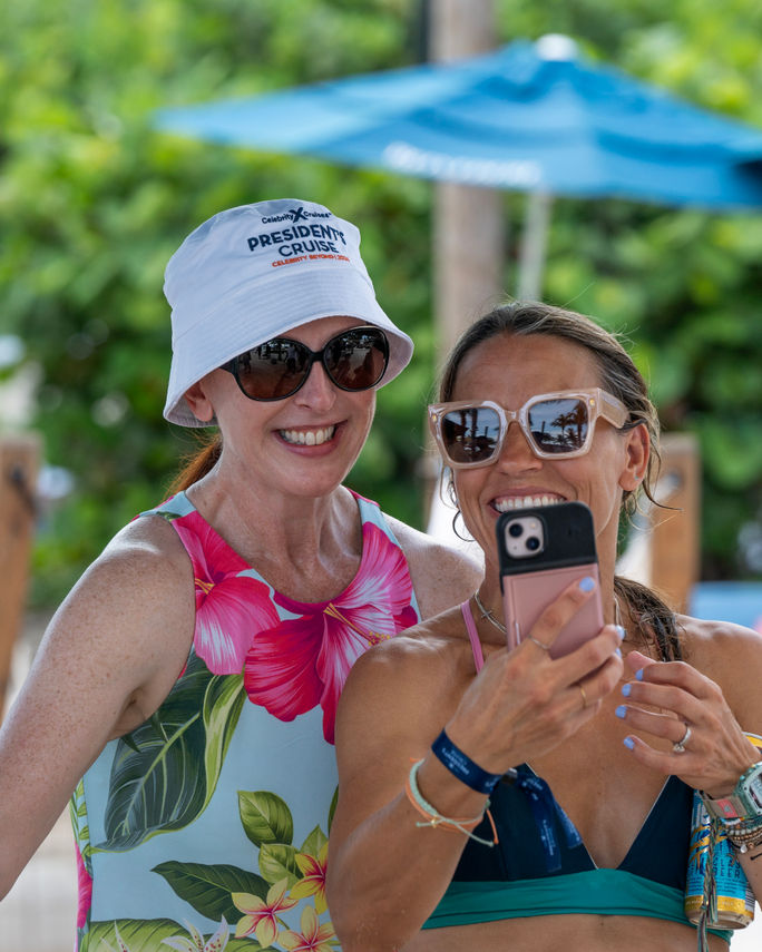 President Laura Hodges Bethge takes a photo with a guest during Celebrity Cruises' 2024 Presidential Cruise.