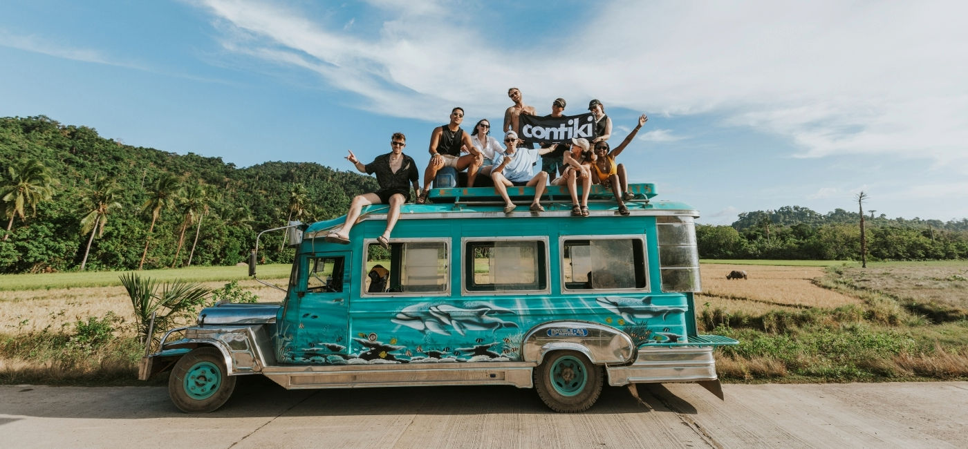 Image: A Contiki group poses on top of a Jeepney in the Philippines. (Photo Credit: Contiki)