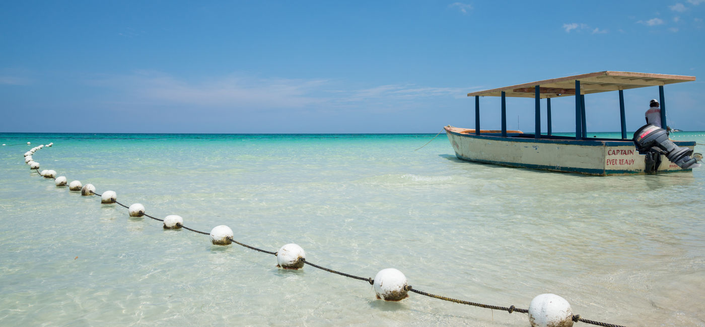 Image: Tourists boat on the turquoise waters of Negril, Jamaica (Photo Credit: Travelling Jack)