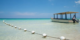 Tourists boat on the turquoise waters of Negril, Jamaica