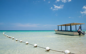 Tourists boat on the turquoise waters of Negril, Jamaica