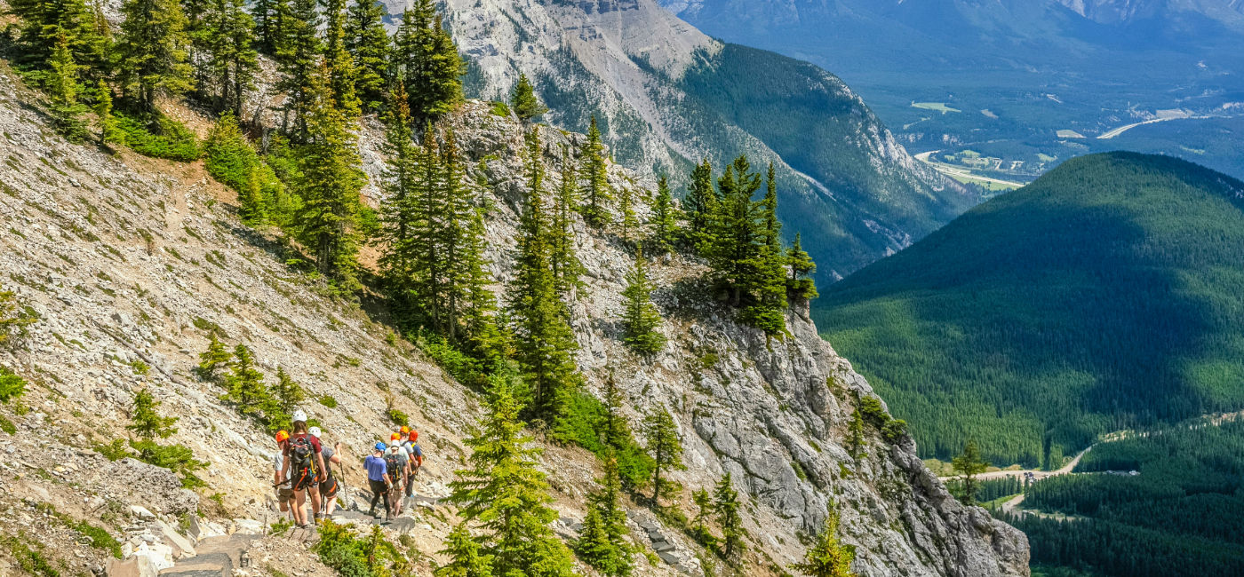 Image: A tour group hikes the mountains on a tour in Canada. (Photo Credit: TTC Tour Brands)