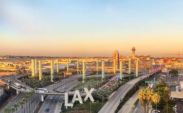 Overview of LAX airport with control tower and aircraft taken from hotel room