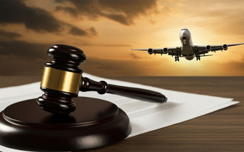 A gavel rests on legal documents with an airplane in the background, symbolizing aviation law and justice in the airline industry.