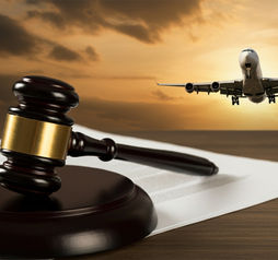 A gavel rests on legal documents with an airplane in the background, symbolizing aviation law and justice in the airline industry.