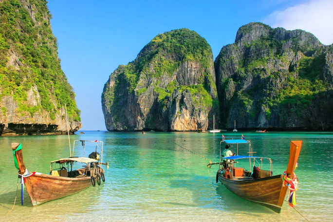 Longtail boats anchored at Maya Bay on Phi Phi Leh Island, Krabi Province, Thailand.