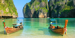 Longtail boats anchored at Maya Bay on Phi Phi Leh Island, Krabi Province, Thailand.