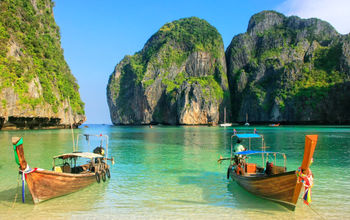 Longtail boats anchored at Maya Bay on Phi Phi Leh Island, Krabi Province, Thailand.