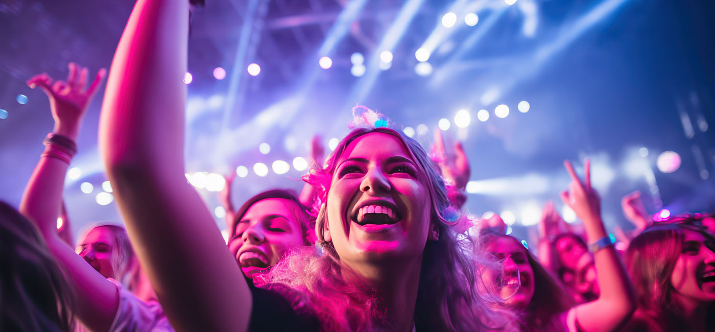 Image: Fans cheering at a music concert. (Photo Credit: kora / Adobe Stock)