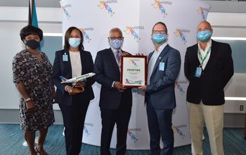 An airport ceremony commemorating Frontier's inaugural flight from Miami to Nassau, The Bahamas