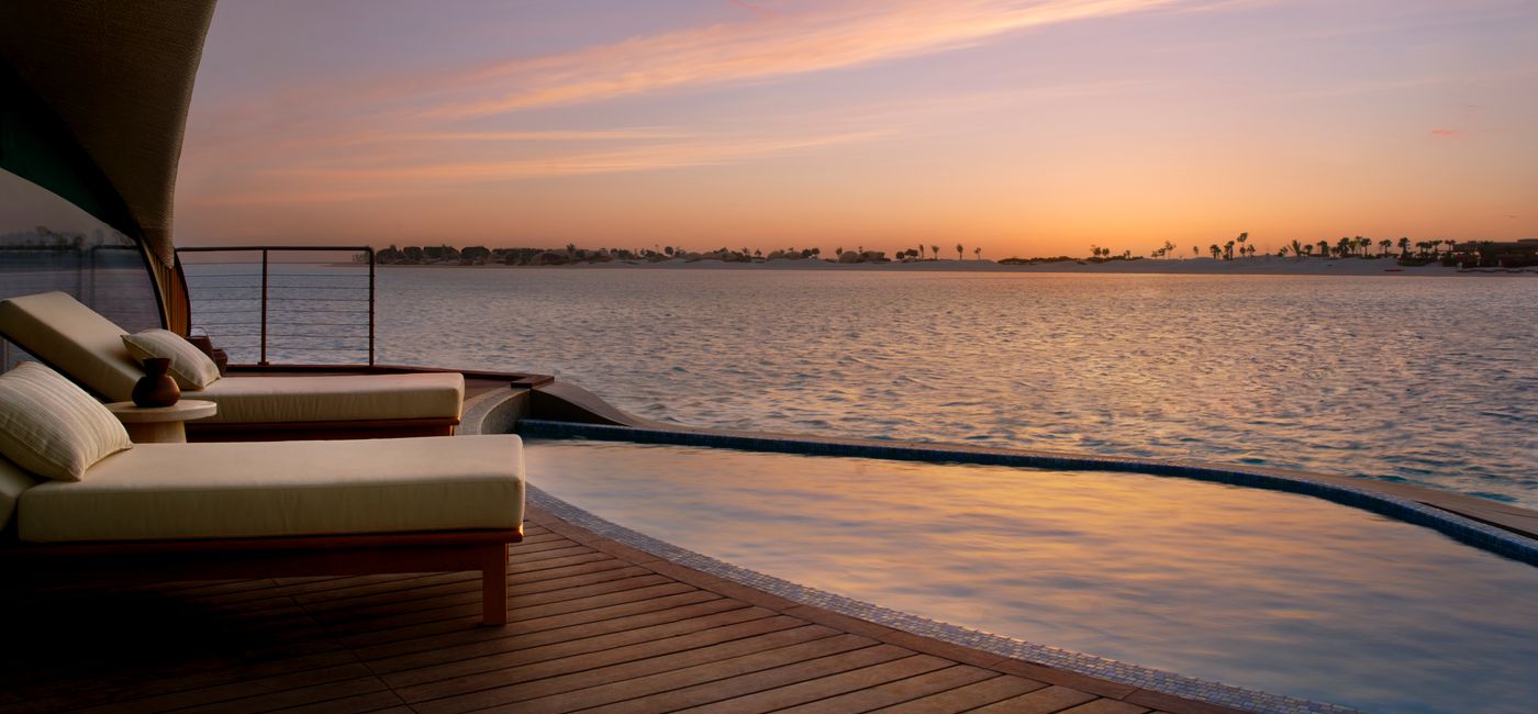 Image: An overwater pool at Nujuma, a Ritz-Carlton Reserve (Photo Credit: Marriott)