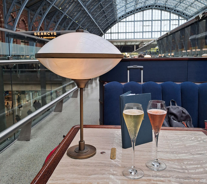 Two glasses of sparkling wine at St. Pancras International railway station in London