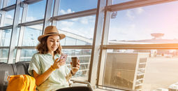 Traveler using her phone at the airport