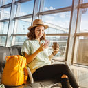 Traveler using her phone at the airport