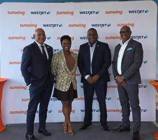 Dr. Ernest Hilaire, left, met with WestJet and Sunwing reps in Toronto