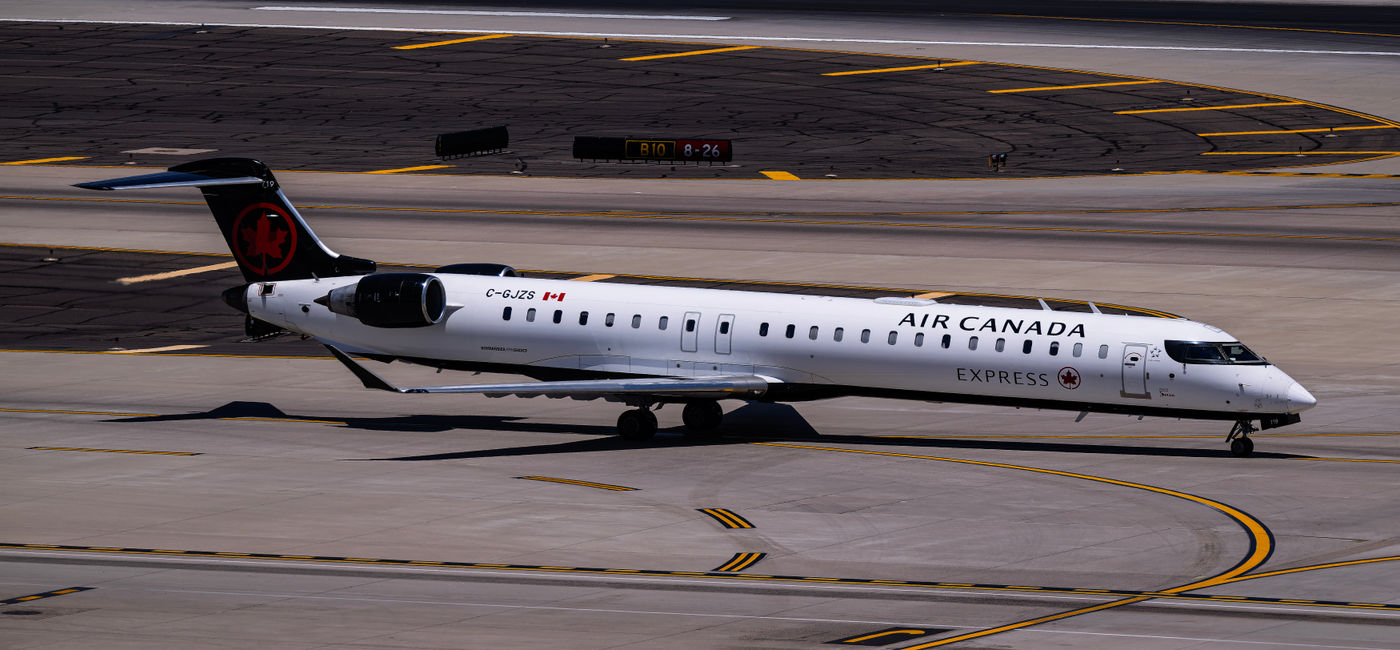 Image: Air Canada Jazz Bombardier CRJ900 C-GJZS landing on runway 26 at Phoenix Sky Harbor Intl. Airport. (Photo Credit: Adobe Stock)
