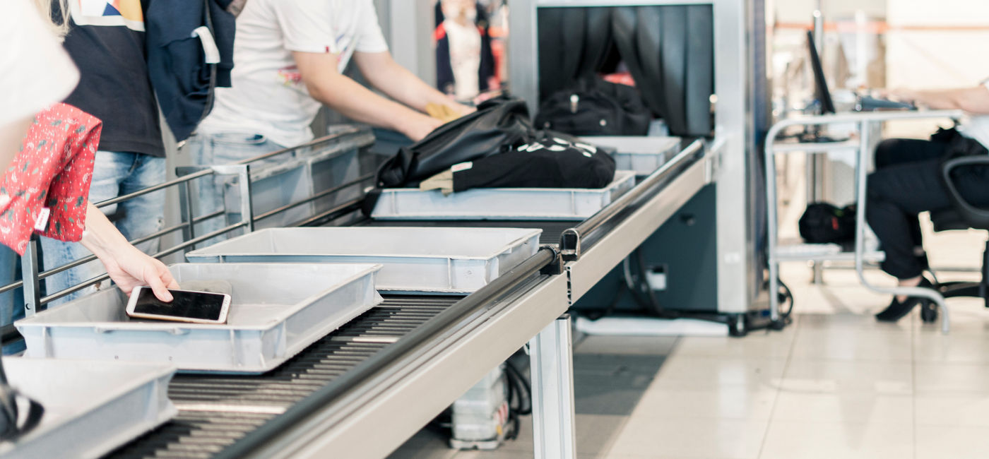Image: Travelers passing through a TSA Airport Security scanning system.  (Photo Credit: Adobe Stock/Mihail)