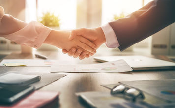 Business handshake in an office