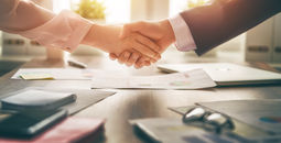 Business handshake in an office