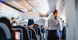 Flight attendants serving passengers.