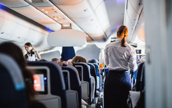 Flight attendants serving passengers. 