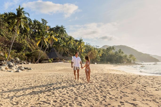 A couple walks on the beach A couple walks on the beach