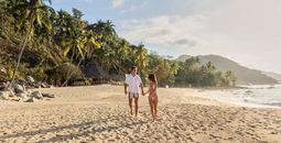 A couple walks on the beach