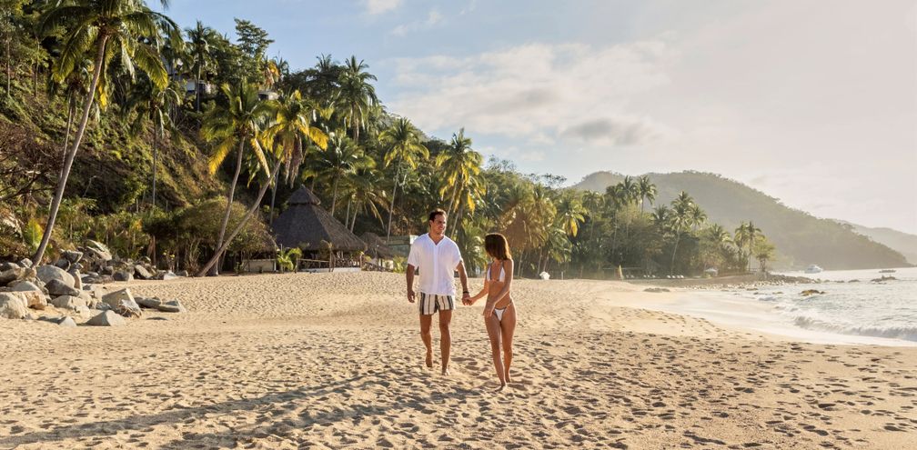 A couple walks on the beach