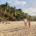 A couple walks on the beach