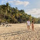 A couple walks on the beach