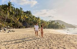A couple walks on the beach