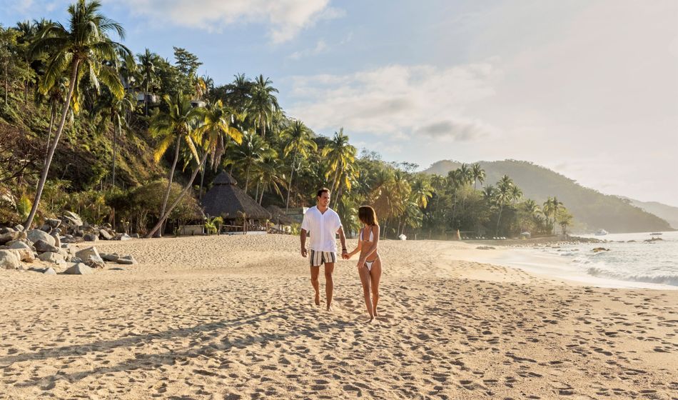 A couple walks on the beach