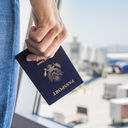 Traveler holding a United States passport at the airport.