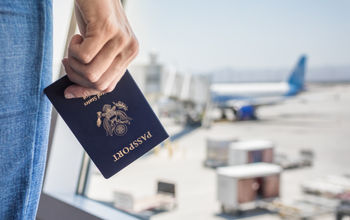 Traveler holding a United States passport at the airport.