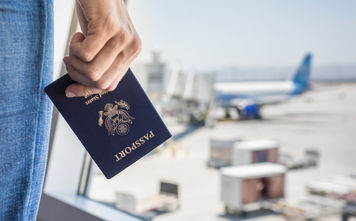 Traveler holding a United States passport at the airport.