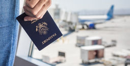 Traveler holding a United States passport at the airport.